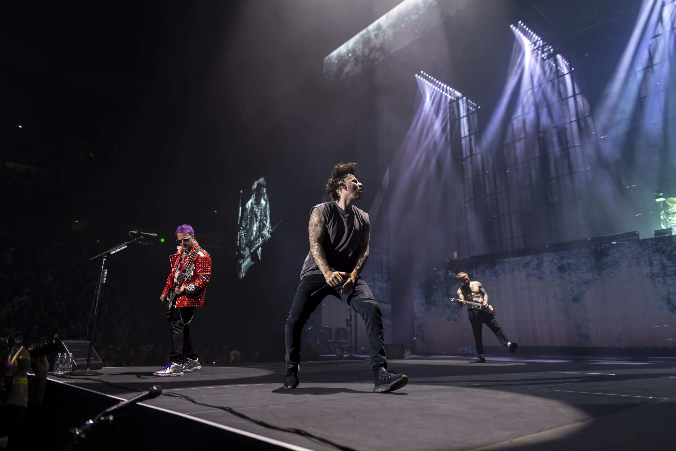 Avenged Sevenfold performs under sweeping lights at Ball Arena.