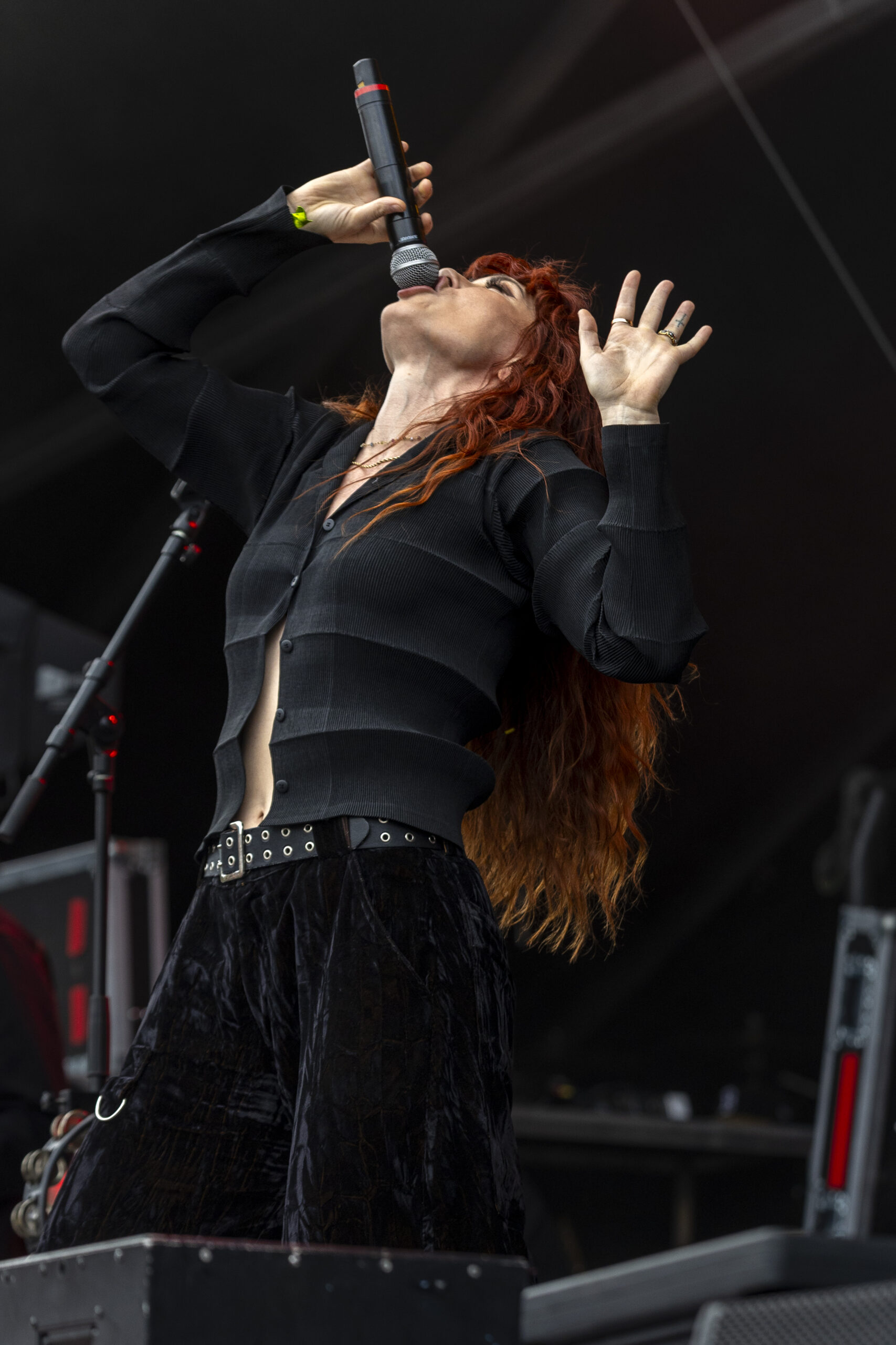 Red-haired vocalist performs with an expressive gesture at Outside Days.