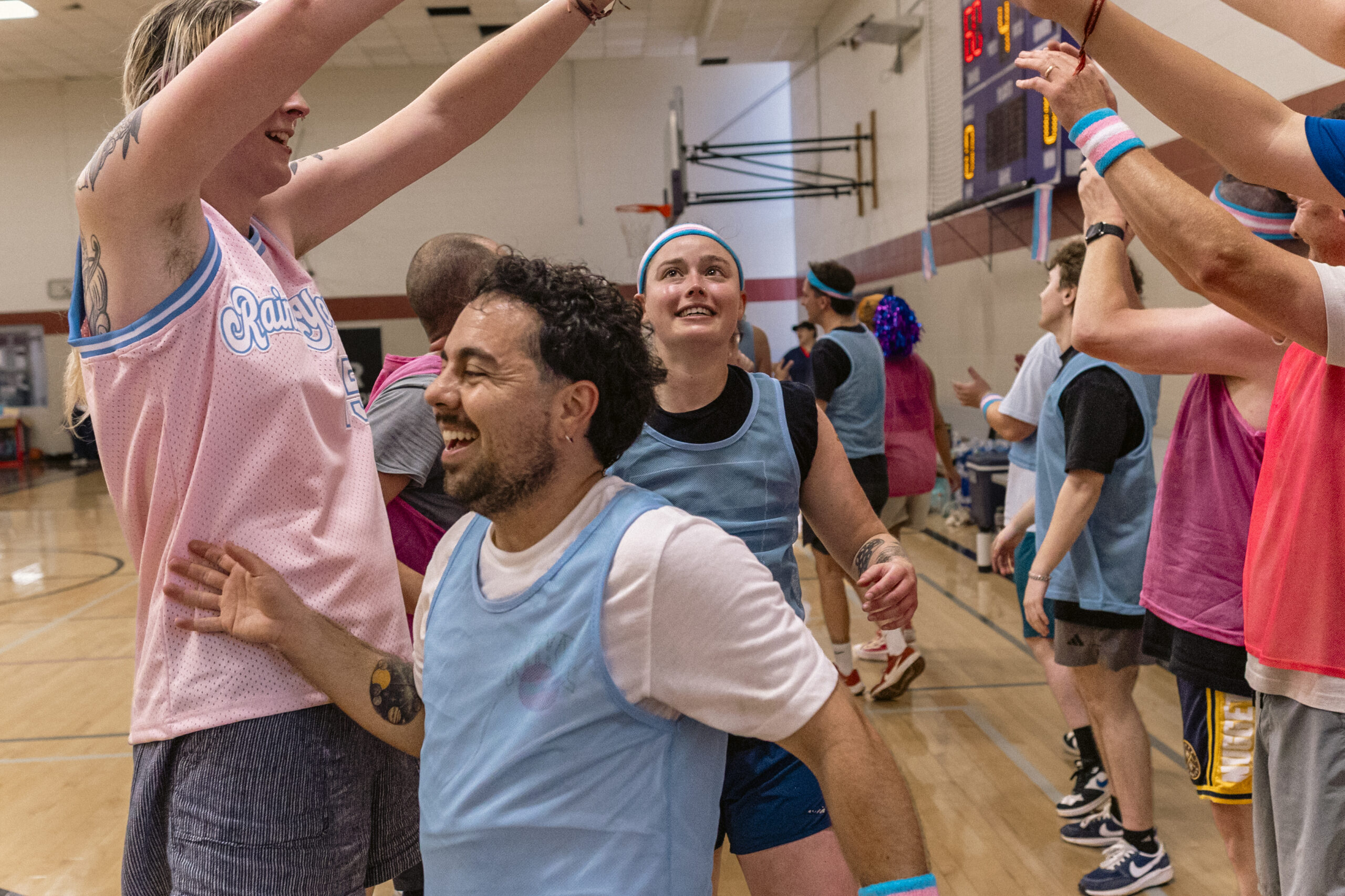 Players celebrate together after a trans community basketball game.